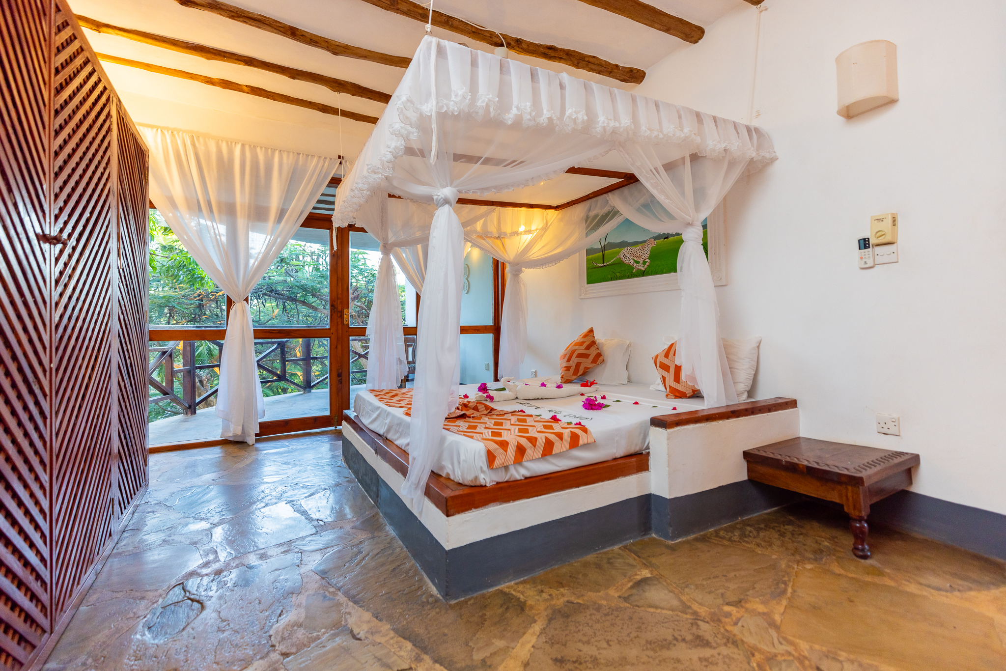 Welcoming four-poster guest room at Silver Rock Boutique Resort